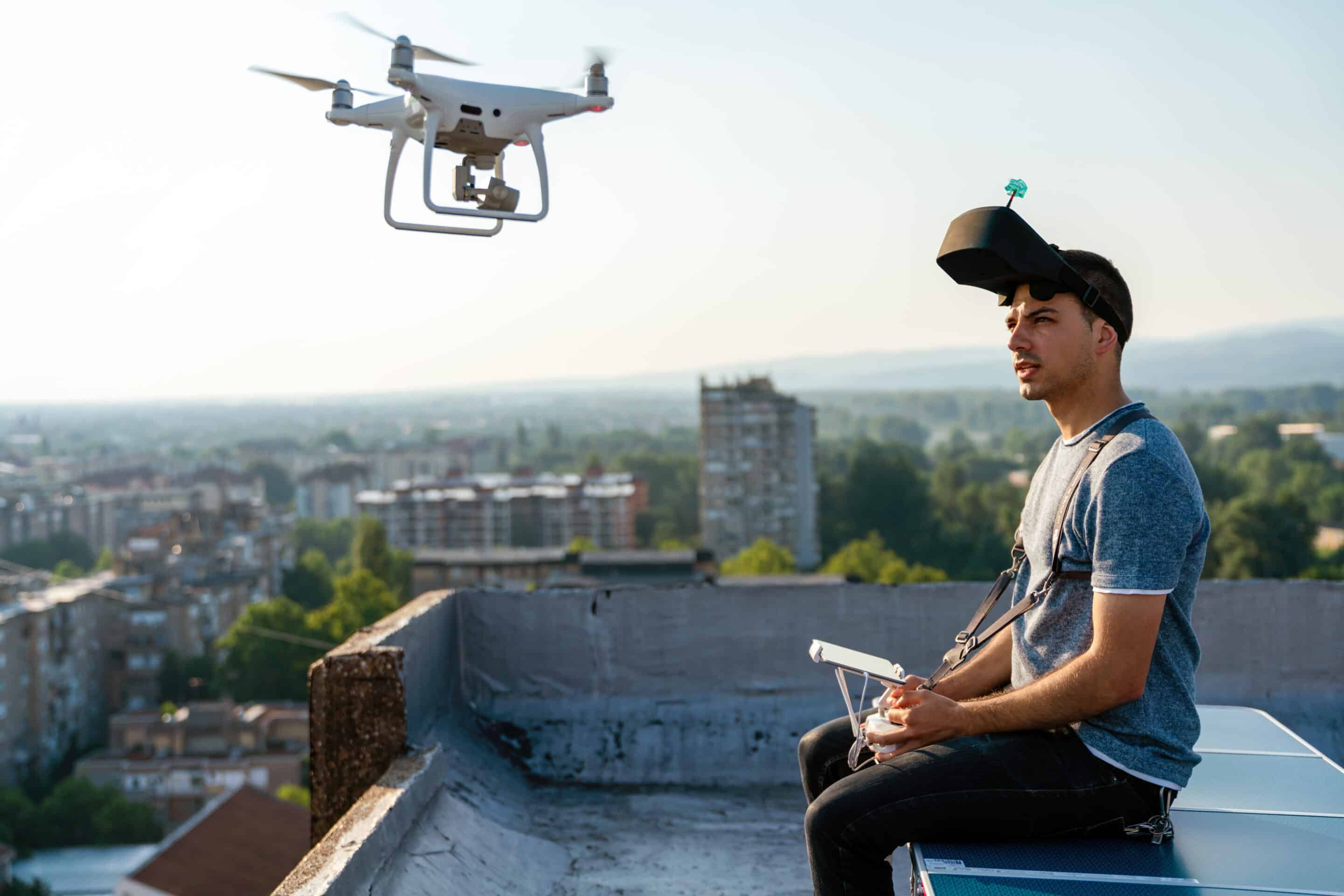 Young man with drone and virtual reality viewer short firm video production agency